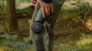 Hiker holding knee while testing the Arc'teryx exoskeleton hiking pants