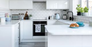 white kitchen with white marble countertops to show how to make a kitchen look expensive on a budget with vinyl wrap