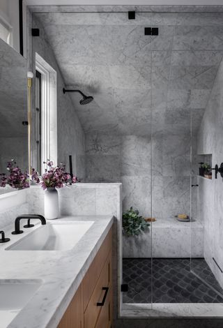 bathroom with double wooden vanity unit and grey shower backsplash
