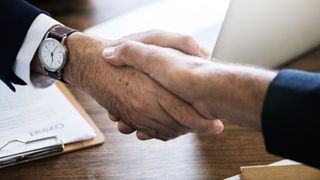 Close up of a handshake between two men.