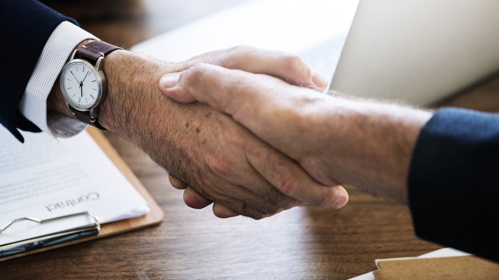 A firm handshake between office staff