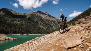 Gravel rider with Pian Palù lake in distance