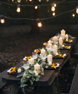 Garden party ideas with wooden table laid with candles