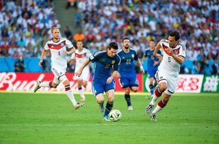 Lionel Messi of Argentina and Mats Hummels and Benedikt Hoewedes of Germany during the World Cup Final match between Germany (1) and Argentina (0) at the Maracana Stadium on July 13, 2014 in Rio de Janeiro, Brazil