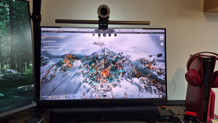 A picture of the Acer Predator X32QFS gaming monitor next to an LG productivity screen and a Volcanic Red PS5 Slim