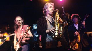 Ian McDonald (front) onstage in 1995 with Roy Wood, Steve Howe and Tom Petersson