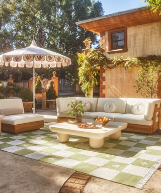 italian patio styled up with a retro patio umbrella and green and white checkerboard rug