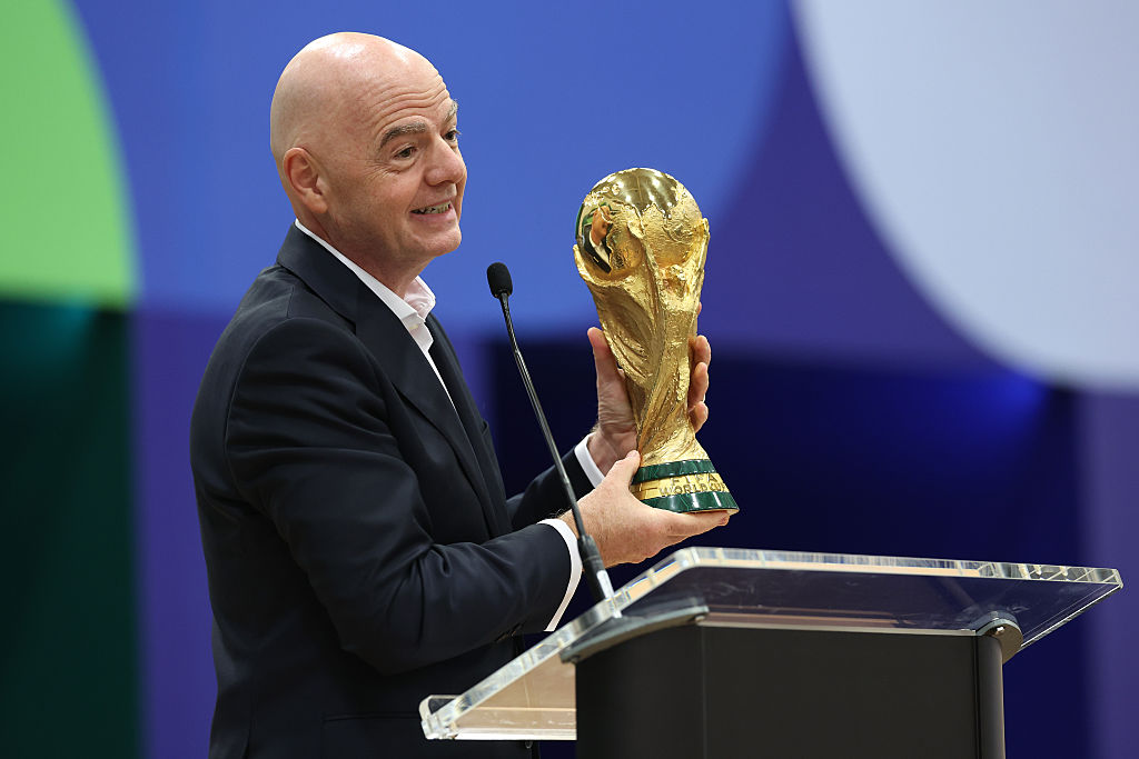 FIFA President Gianni Infantino holds the FIFA World Cup winner's trophy while speaking during the FIFA World Cup 2026 International Broadcast Center Grand Opening ceremony in 2026 in Dallas, Texas