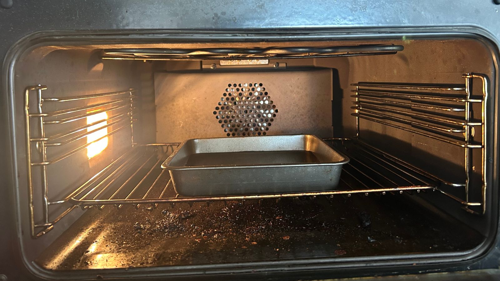 Oven cleaning hack - oven-safe vessel in oven with citric acid