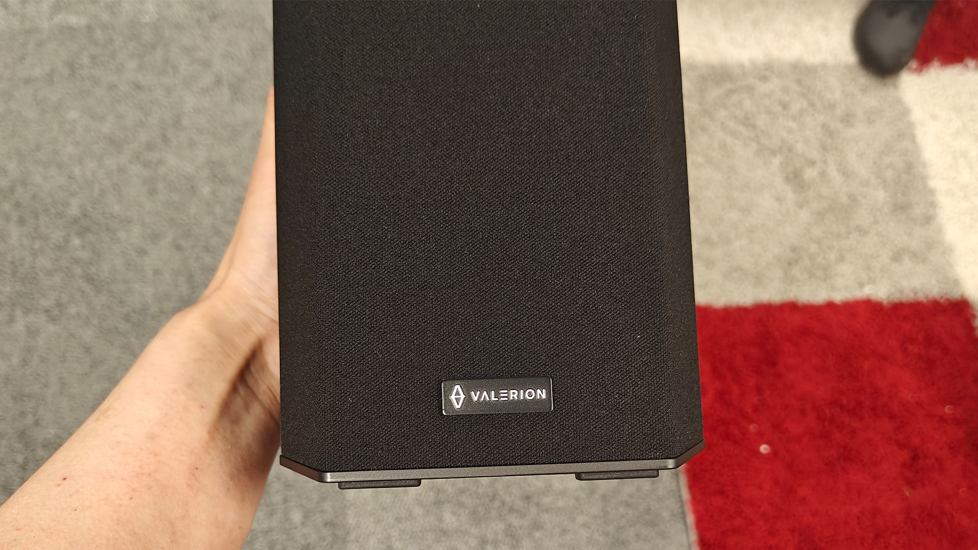 Valerion Thunderbeat 4.1.2 surround sound system satellite speaker held in hand
