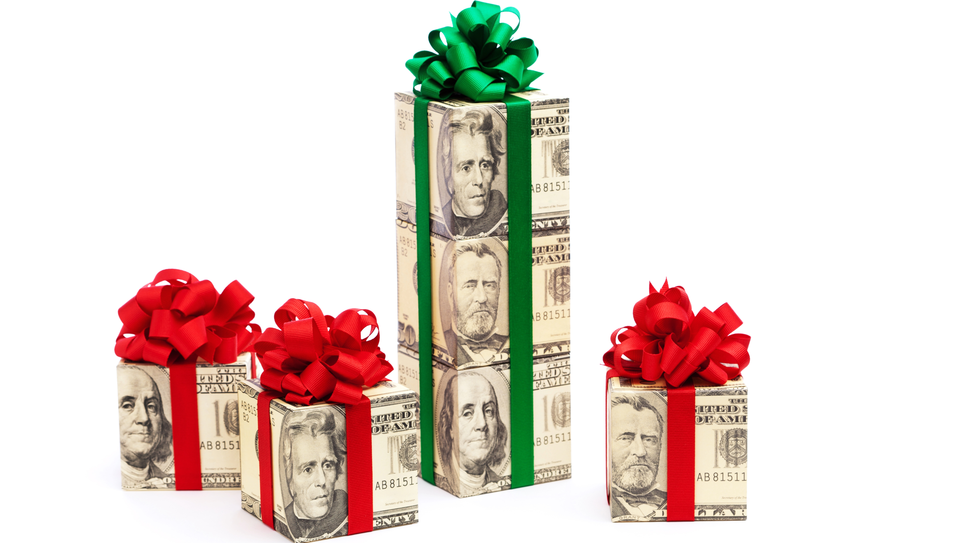 Rolls of $100 bills wrapped with green and red bows as presents