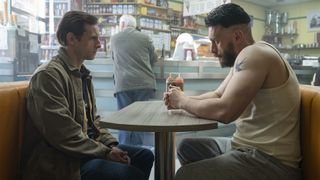 Jamie Bell as Niall and Richard Gadd as Ruben staring intensely at each other across a table in a cafe in Half Man