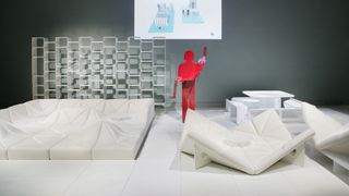 Room divider, origami-like Dune sofa and cream chairs designed by Pierre Paulin