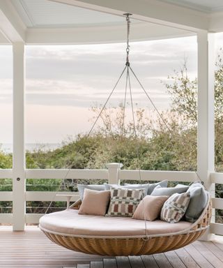 wraparound porch with seaview and hanging chair with cushions