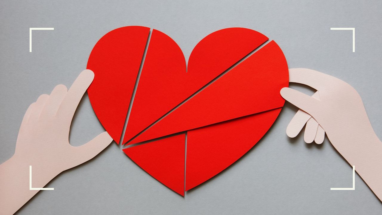 Illustration of two hands building a red heart out of paper, to represent love manifestation 