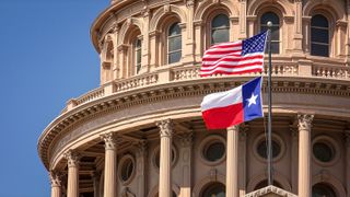 US and Texas state flags flying on the dome of the Texas State Capitol building