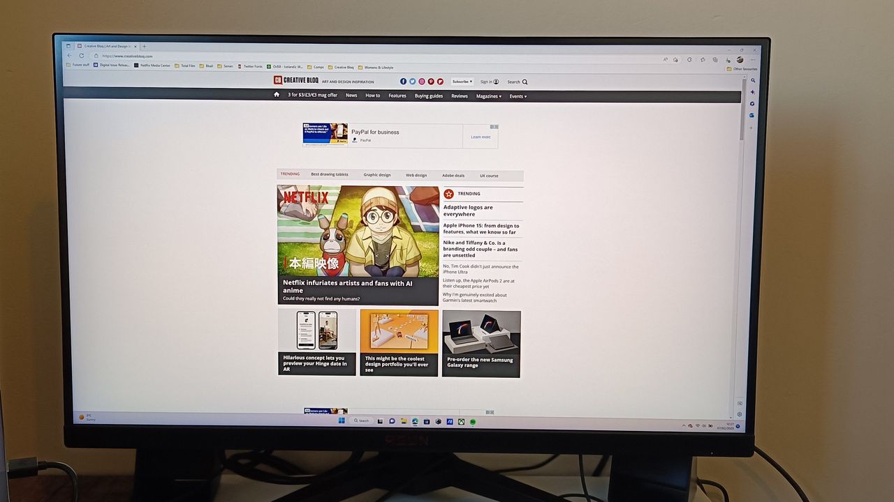 An AOC AGON AG275QZ monitor sitting on a table