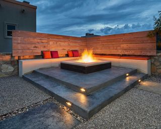 modern seating area with fire pit by Go Designs