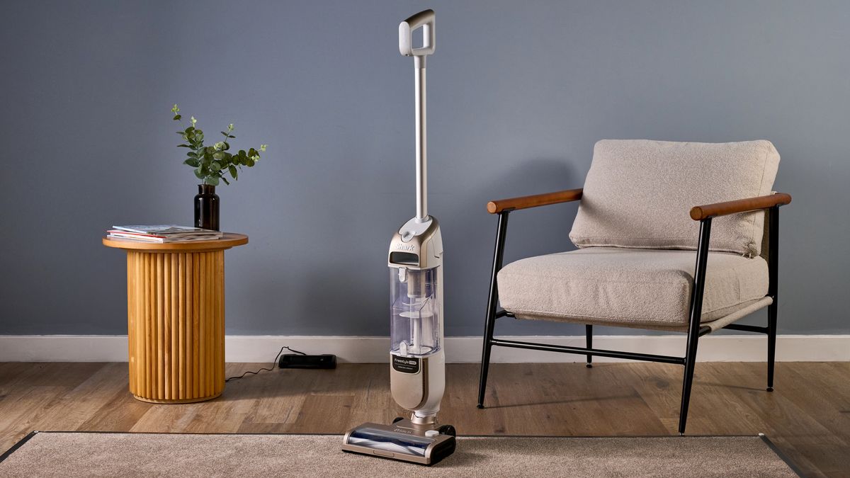 Shark Freestyle Pro cordless upright vacuum standing in front of its dock
