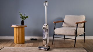 Shark Freestyle Pro cordless upright vacuum standing in front of its dock