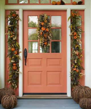 Coral front door with flower garland and swag