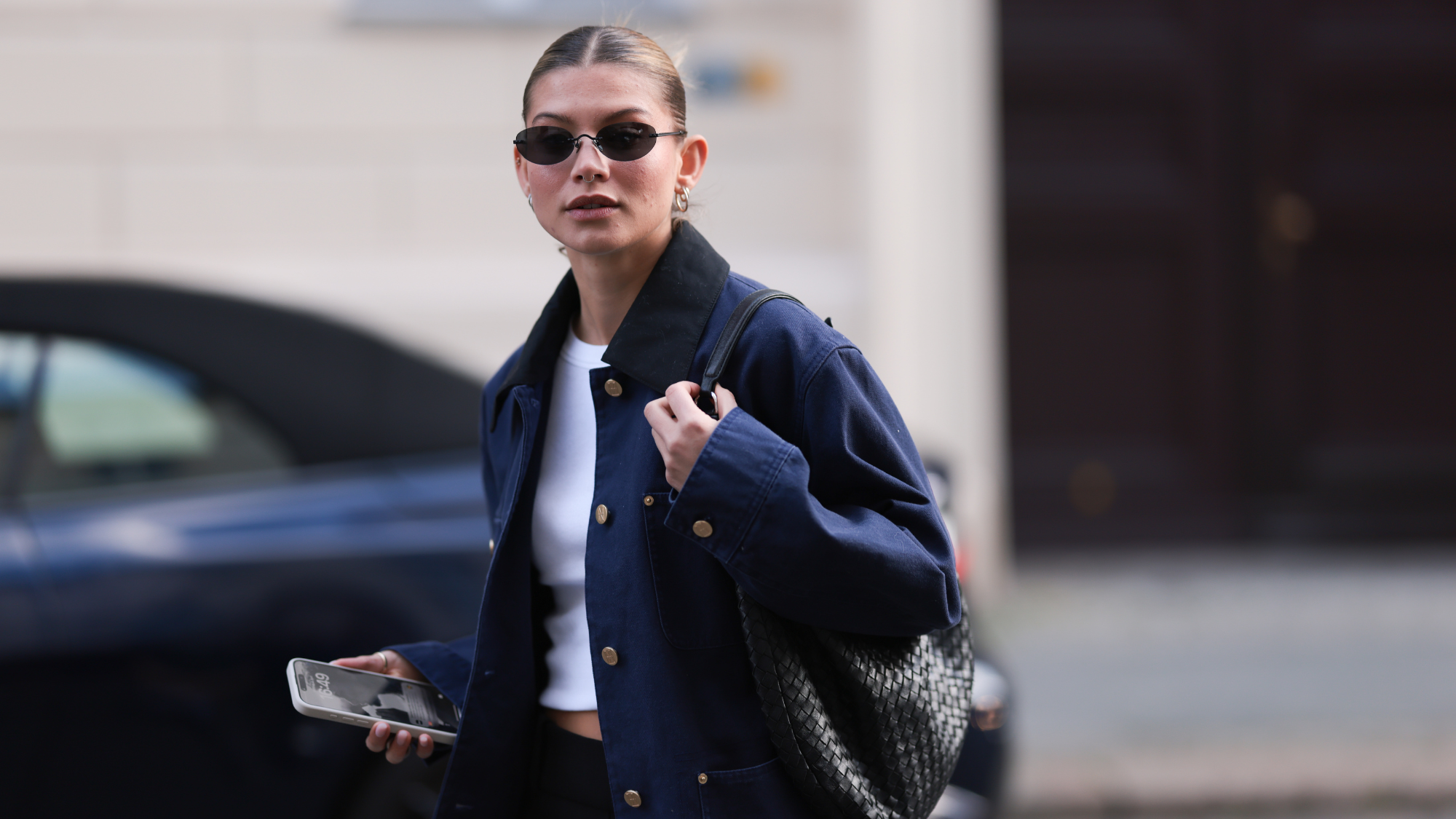 A woman wearing sunglasses posing in the street