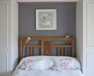 bedroom with dark walls and wooden bed