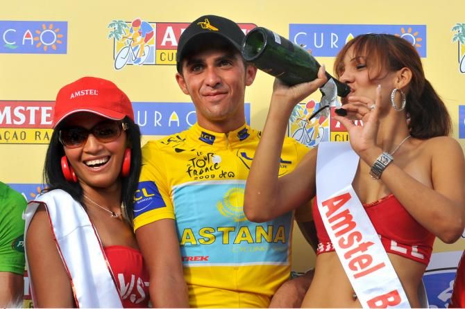 Alberto Contador lets the podium hostess have his champagne