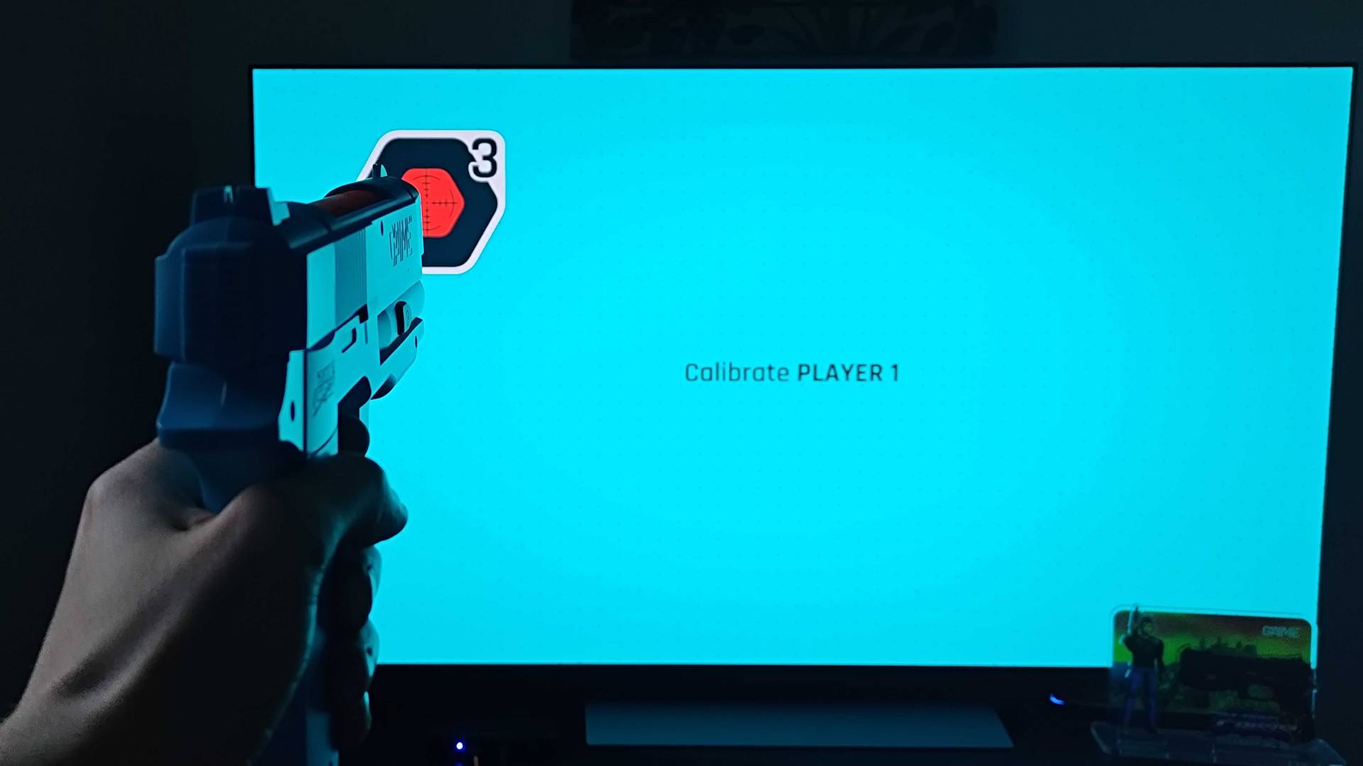 G&#039;AIM&#039;E Time Crisis Lightgun calibration screen with gun pointed at target.