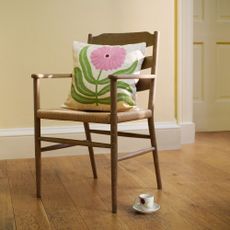 John Lewis Anine Cecile Iverson collection cushion showing a white background with green leaves and pink flower on a chair
