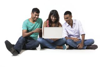 Group of Indian teens using a laptop computer.