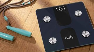 Eufy Smart Scale C1 on the floor beside skipping rope