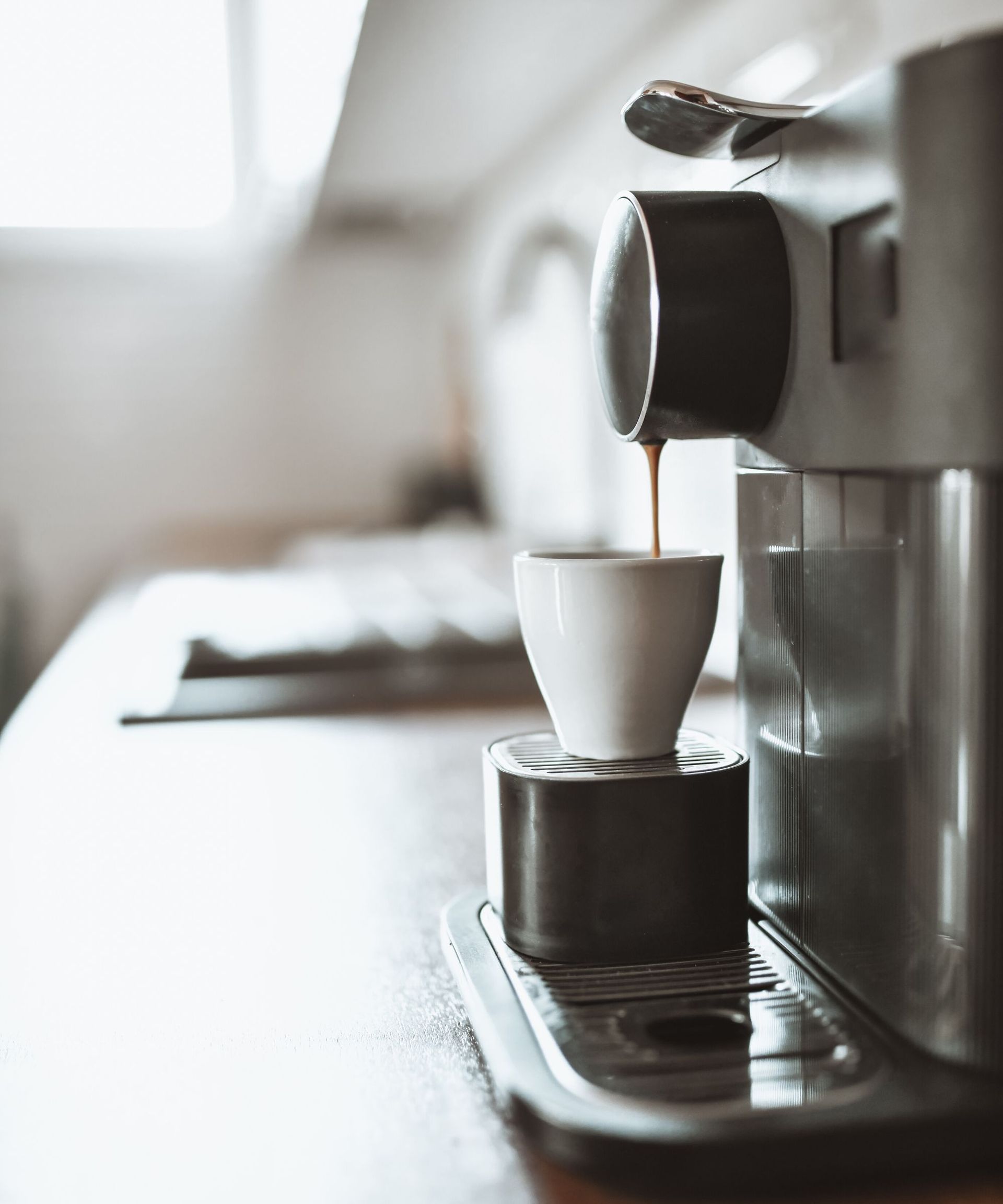 A coffee cup being filled in a coffee mahcine