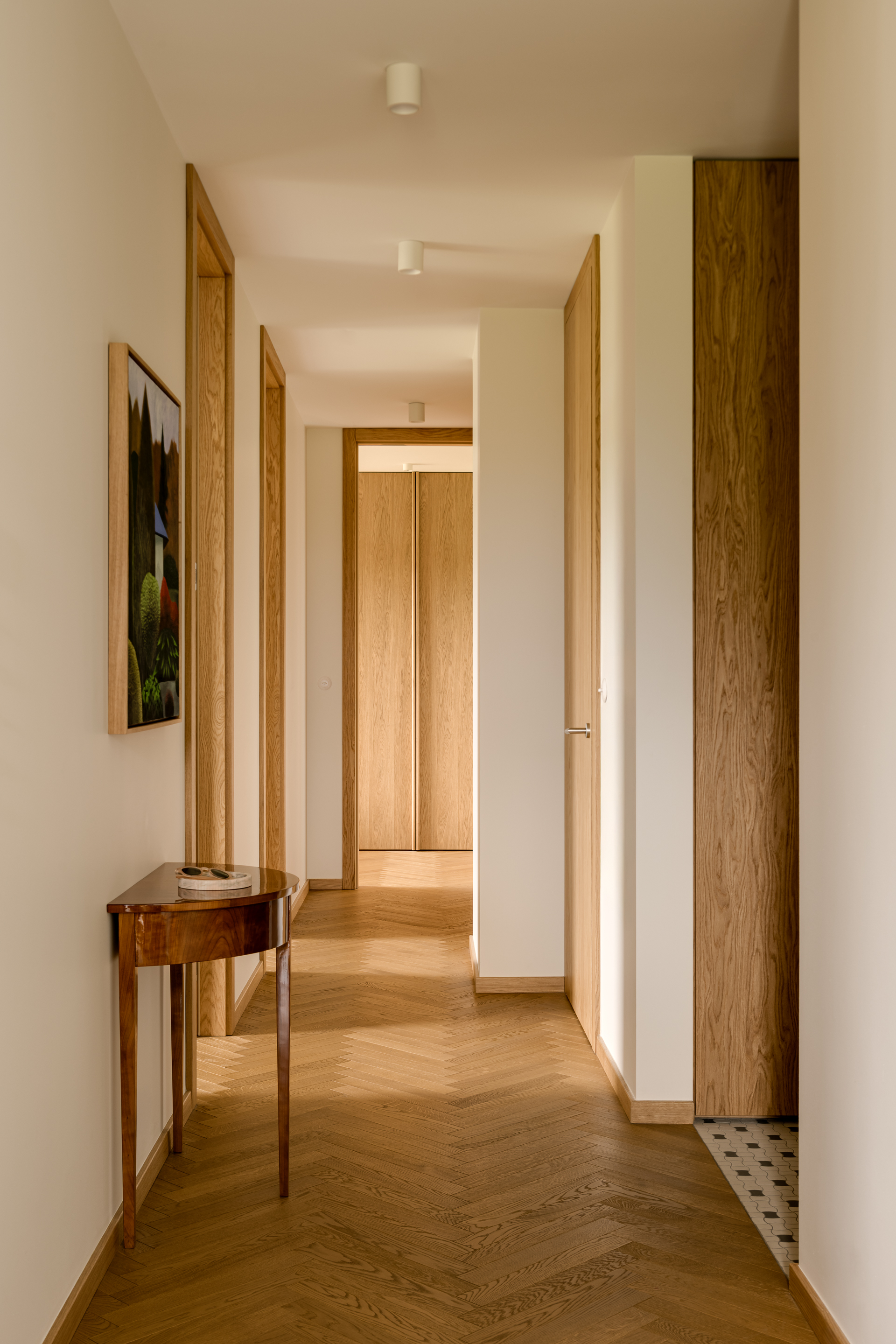 A contemporary hallway with natural oak trim throughout