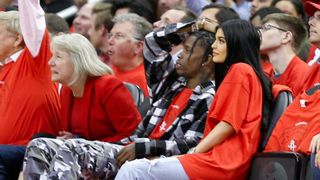 Travis Scott and Kylie Jenner front row at a basketball game.