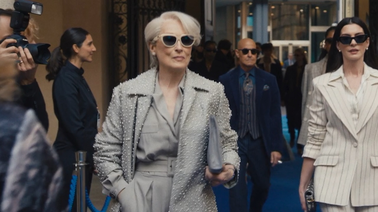 Miranda and Andy walking ahead of Nigel in The Devil Wears Prada 2