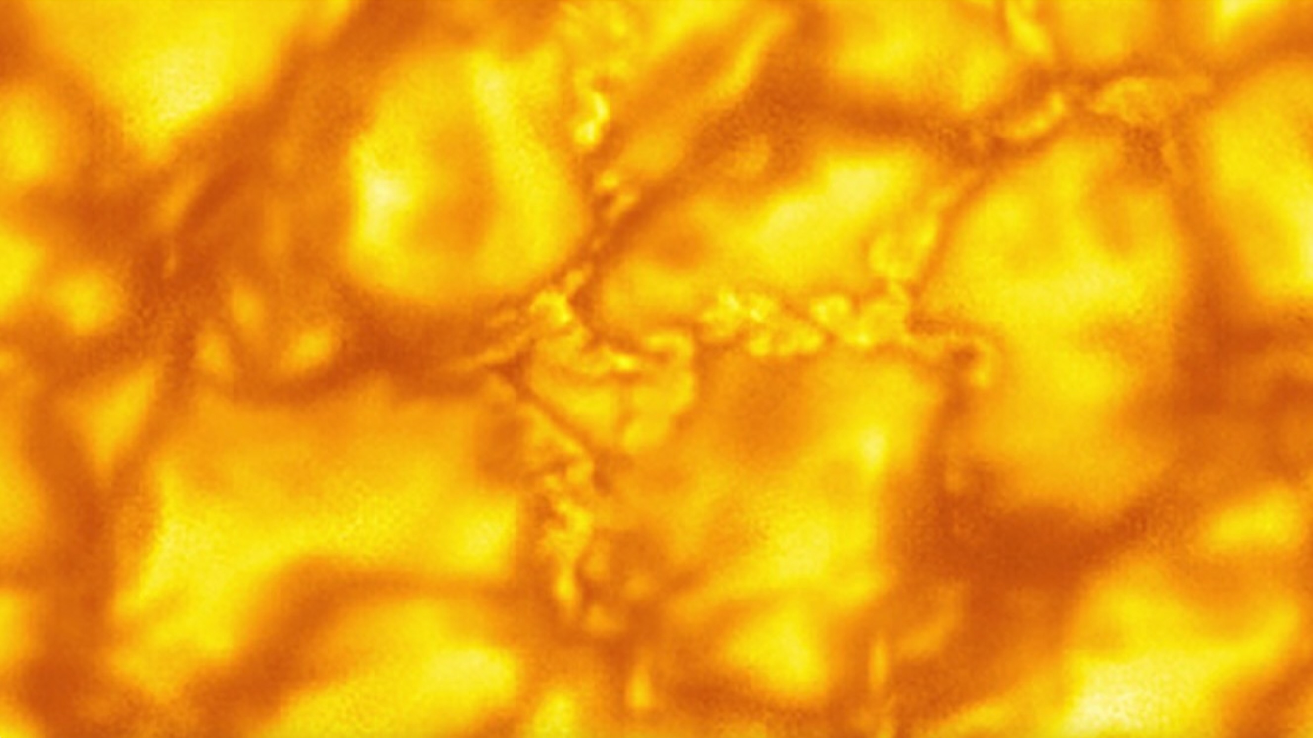 The fine structure of the sun, showing orange-yellow convective bubbles.