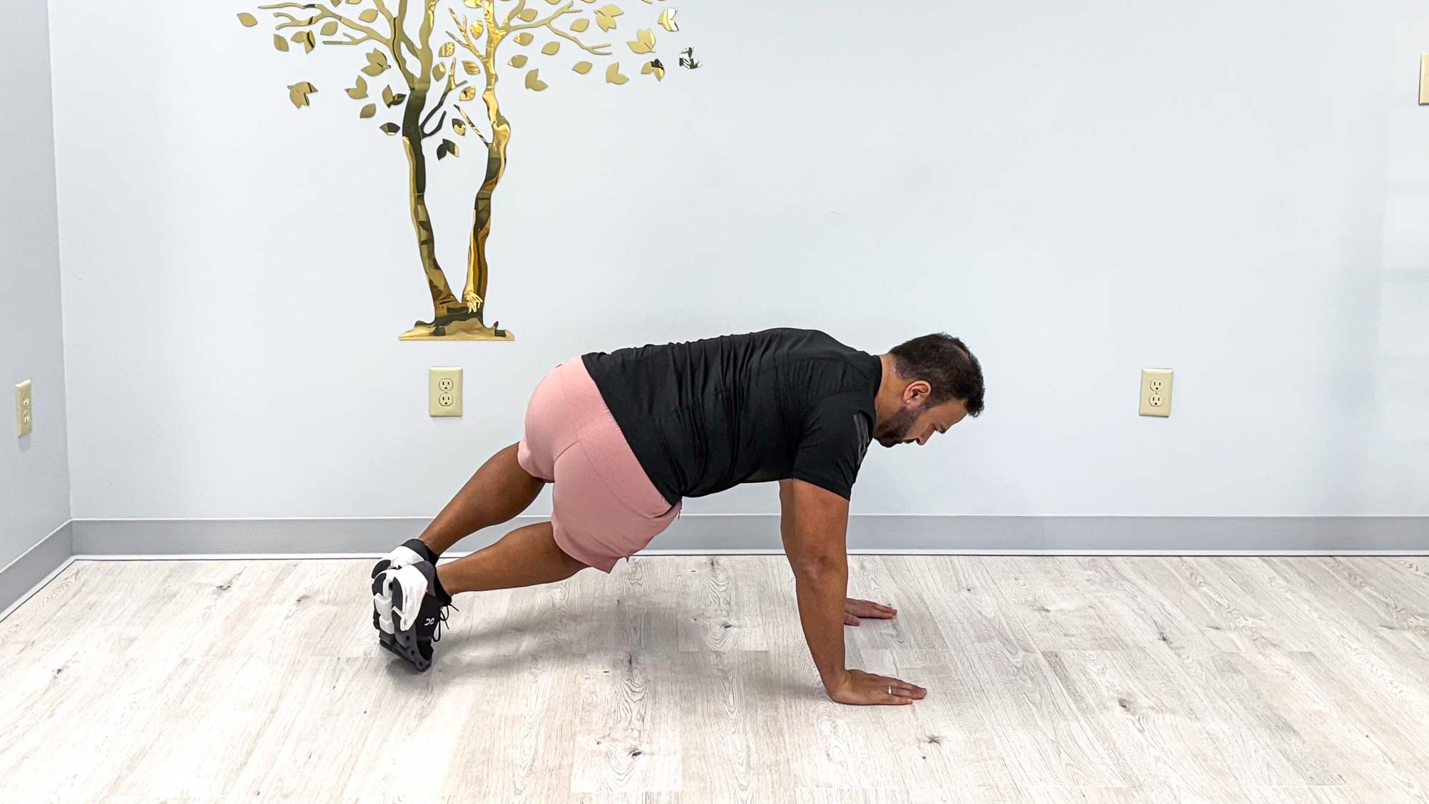 Nico Gonzalez performing the twisted core bear exercise