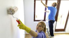 A couple freshening up the walls of their home 