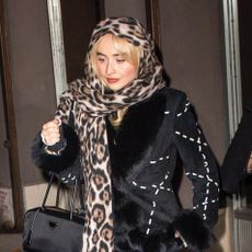 Sabrina Carpenter wearing a leopard-print scarf in NYC