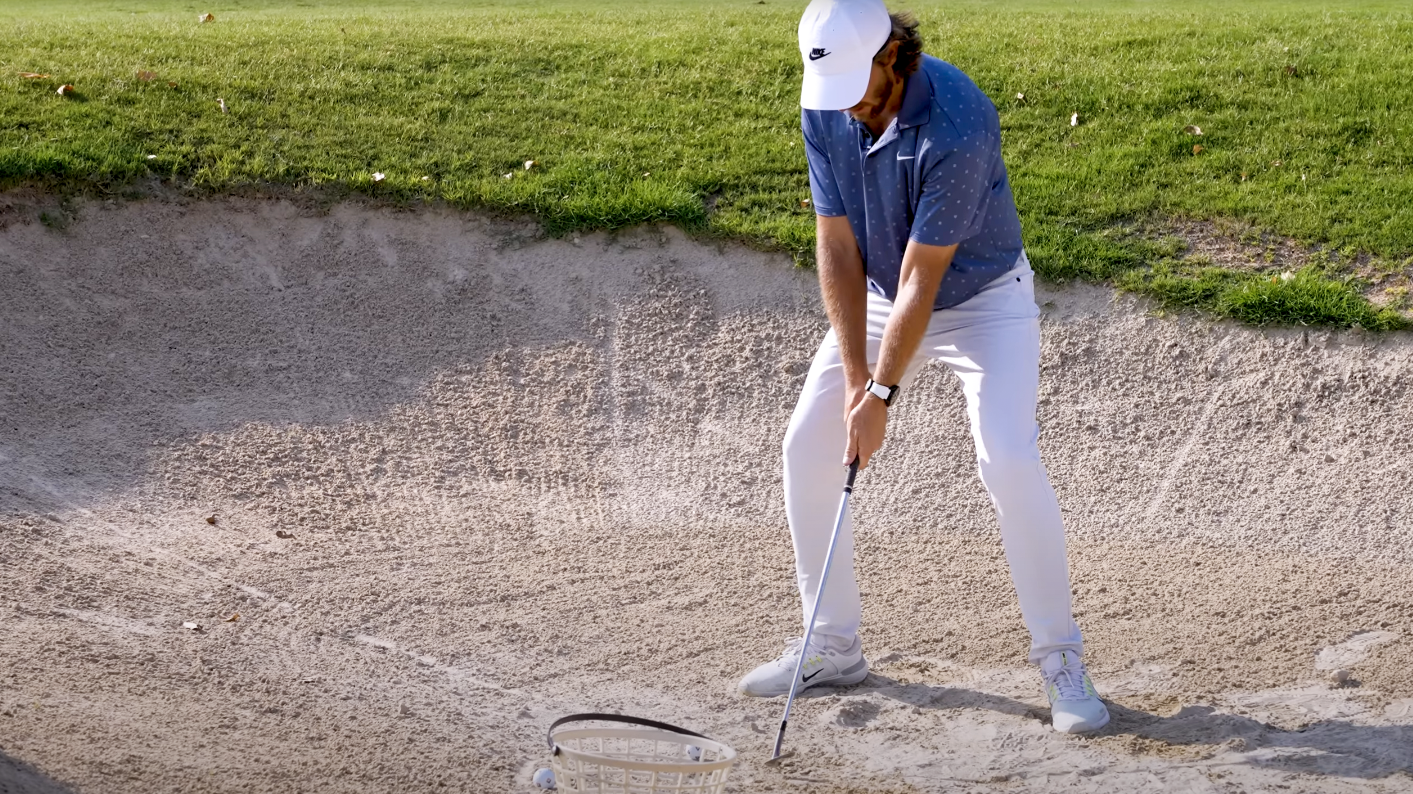 Photo of Tommy Fleetwood hitting a bunker shot left-handed