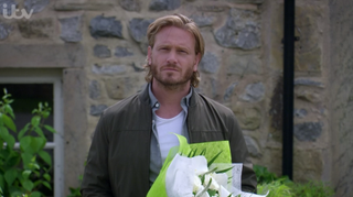 David buys flowers for Victoria in Emmerdale