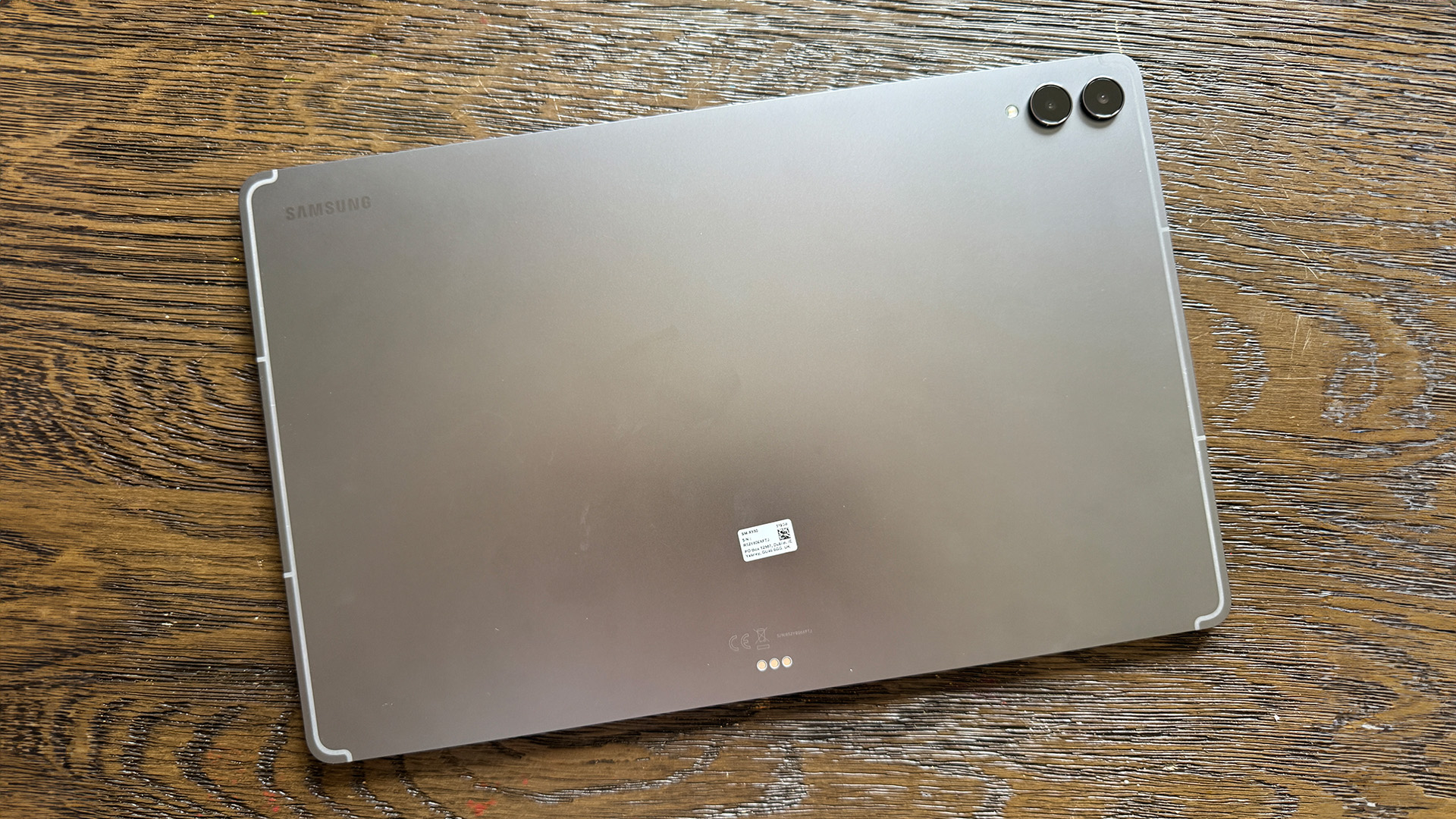 Samsung Galaxy Tab S11 Ultra tablet face down on wooden table showing rear camera array
