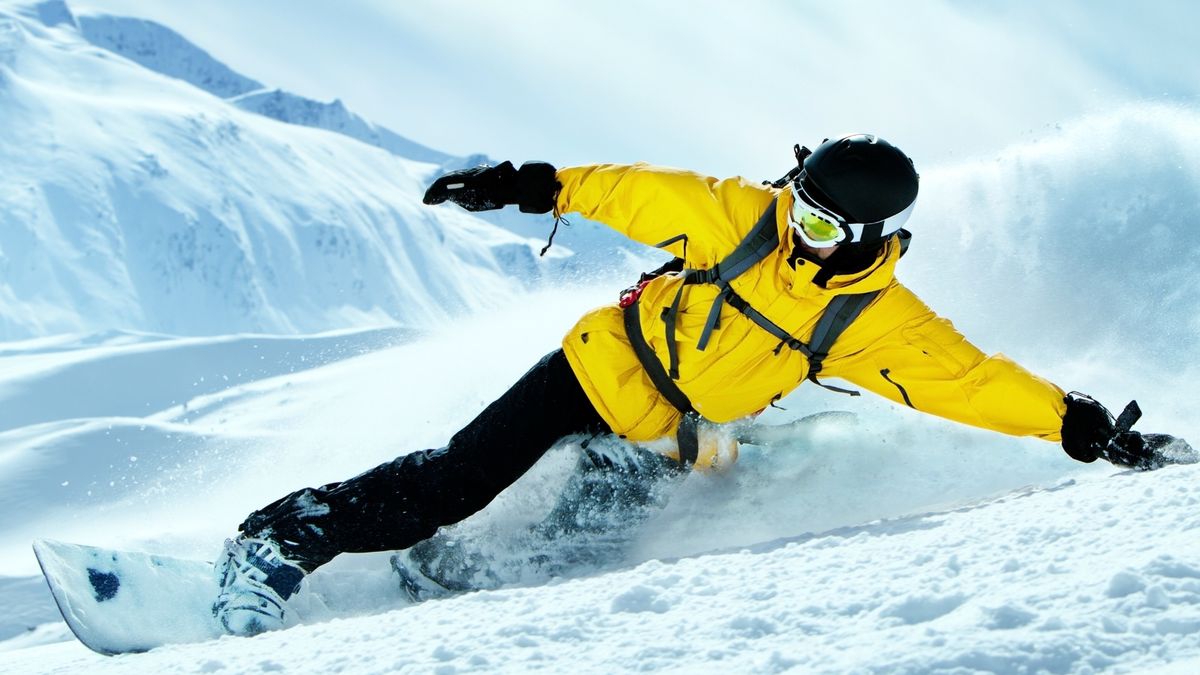 man snowboarding on mountain in India 