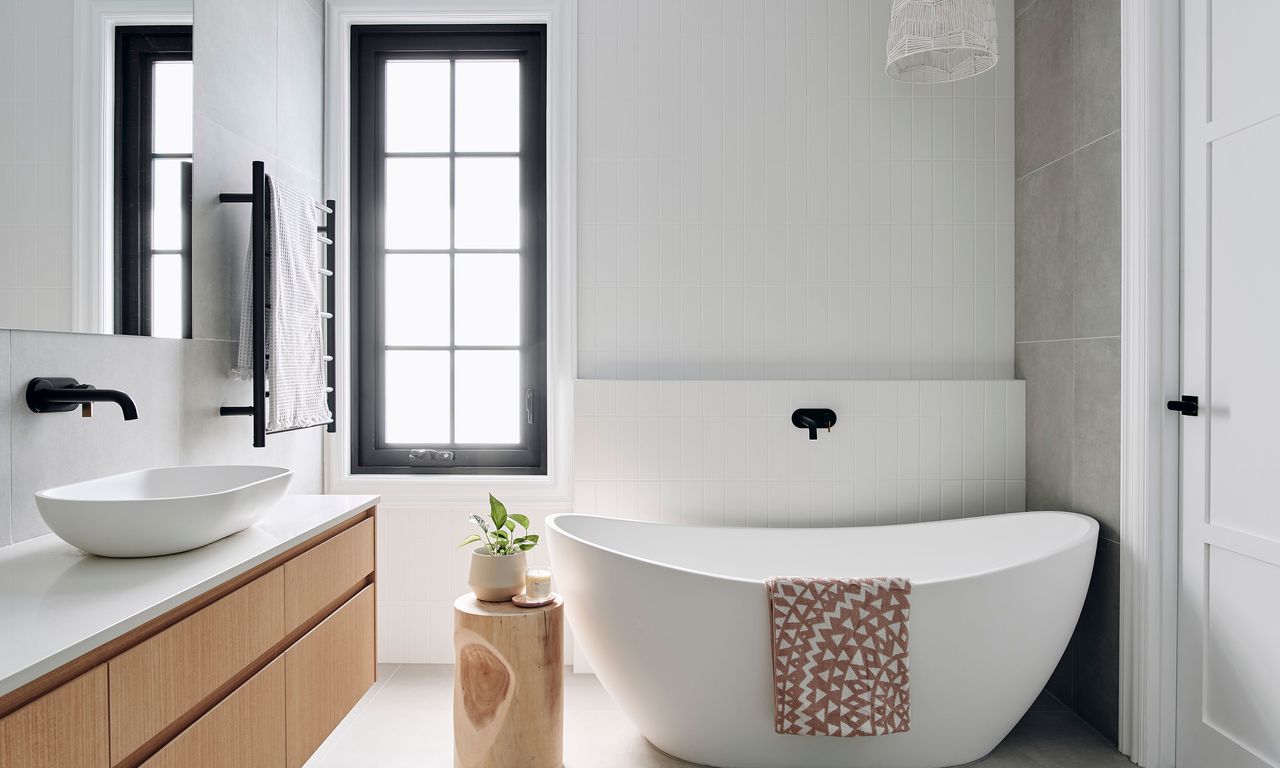 White bathroom with matching tub and crittal style windows