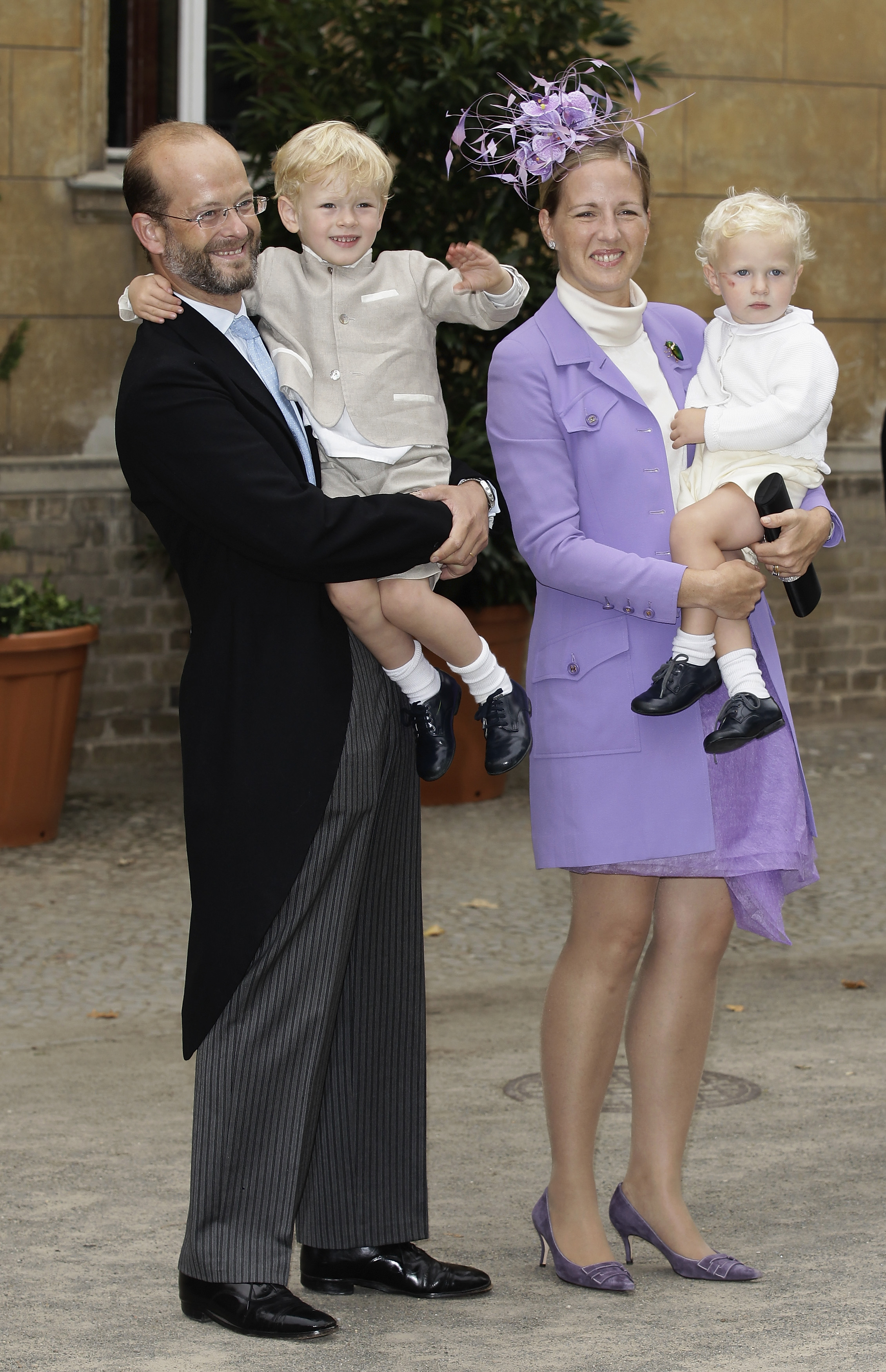 Lord and Lady Nicholas Windsor dressed up and carrying their two young sons