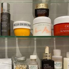 A bathroom cupboard filled with different beauty creams