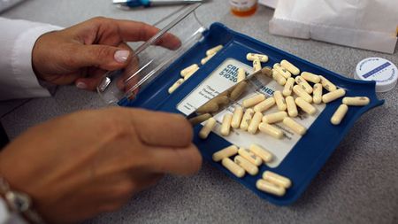 A pharmacist counting out pills