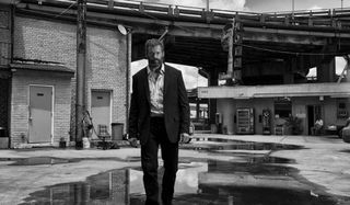Logan Hugh Jackman strides defiantly in black and white