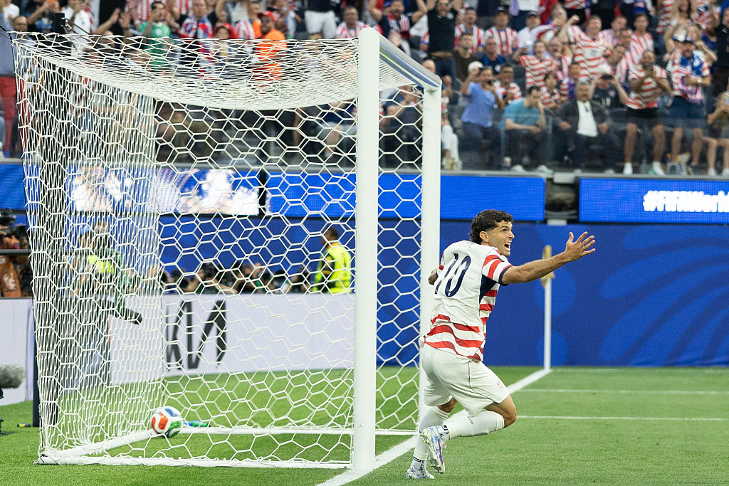 Christian Pulisic celebrates a USA goal against Paraguay